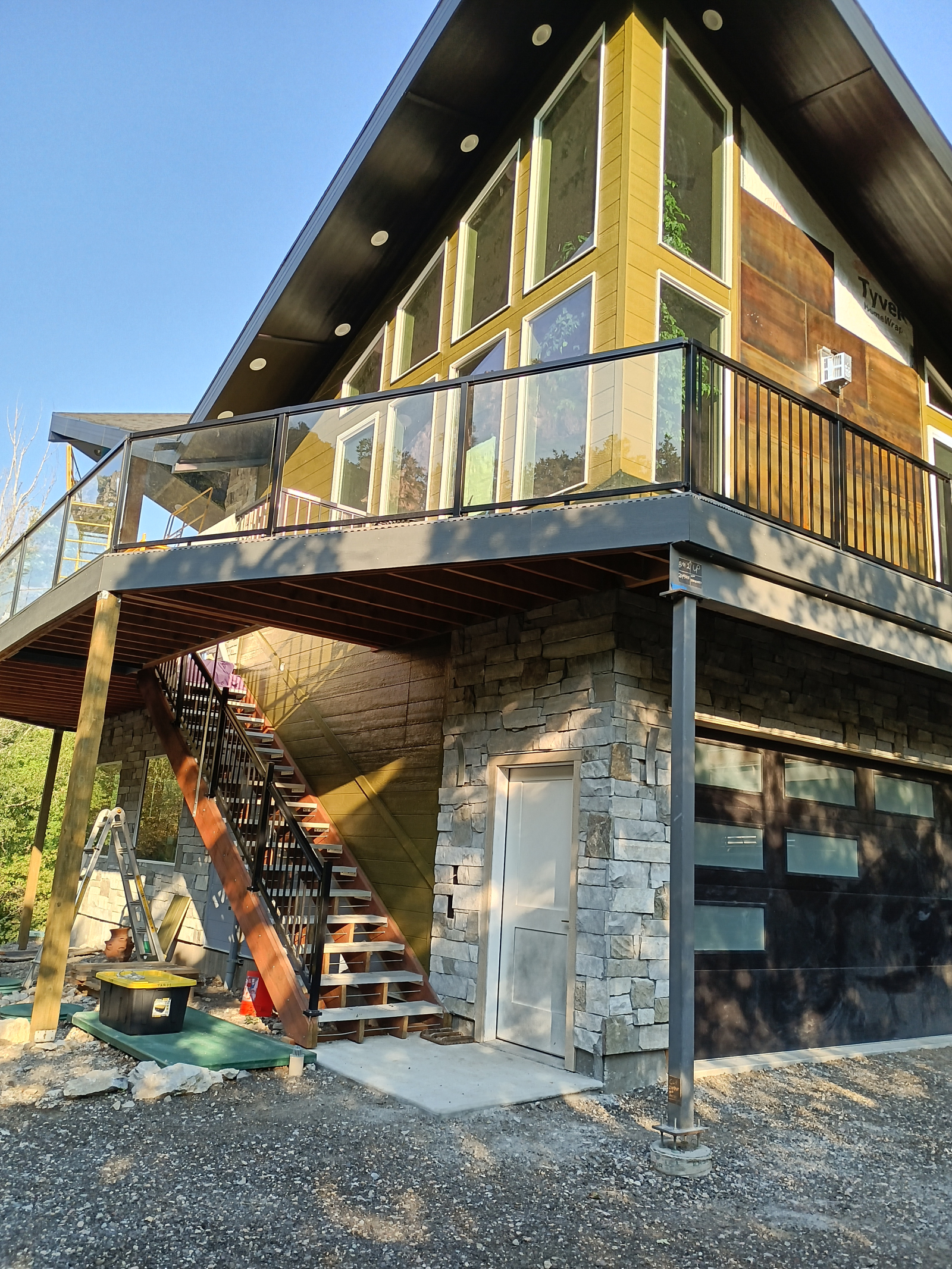View from the driveway showing the Family Room corner with the entry stairs and the drive-under gara ...