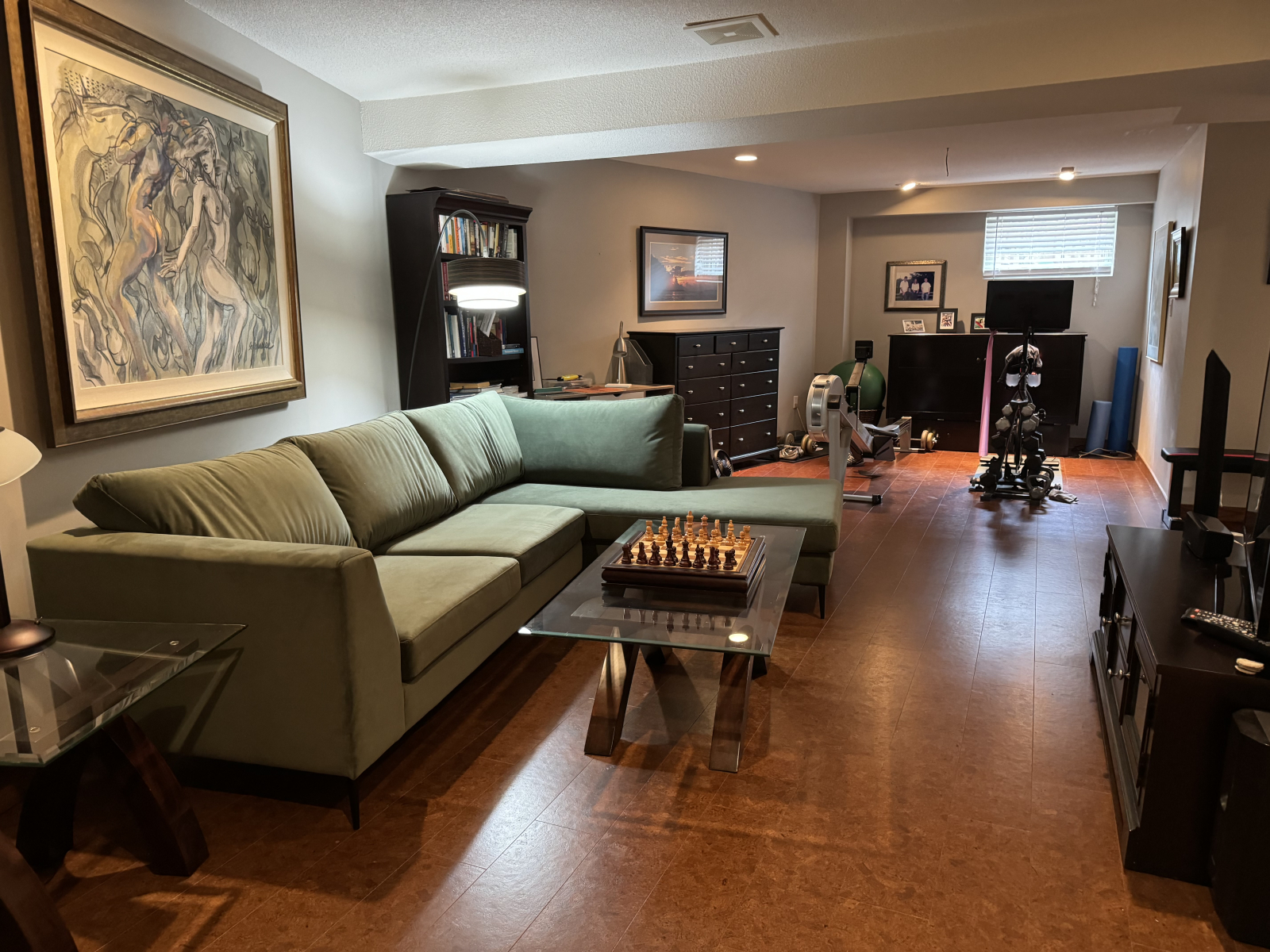 The lower level sitting, tv and fitness areas