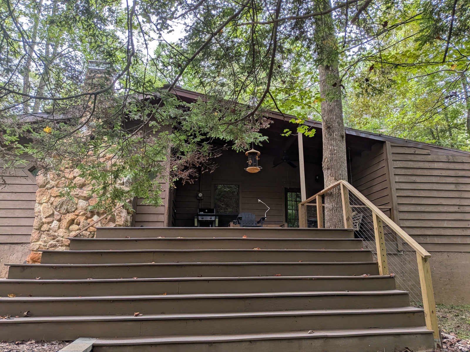 Waterfall stairs on back deck allow for unobstructed views of the woods