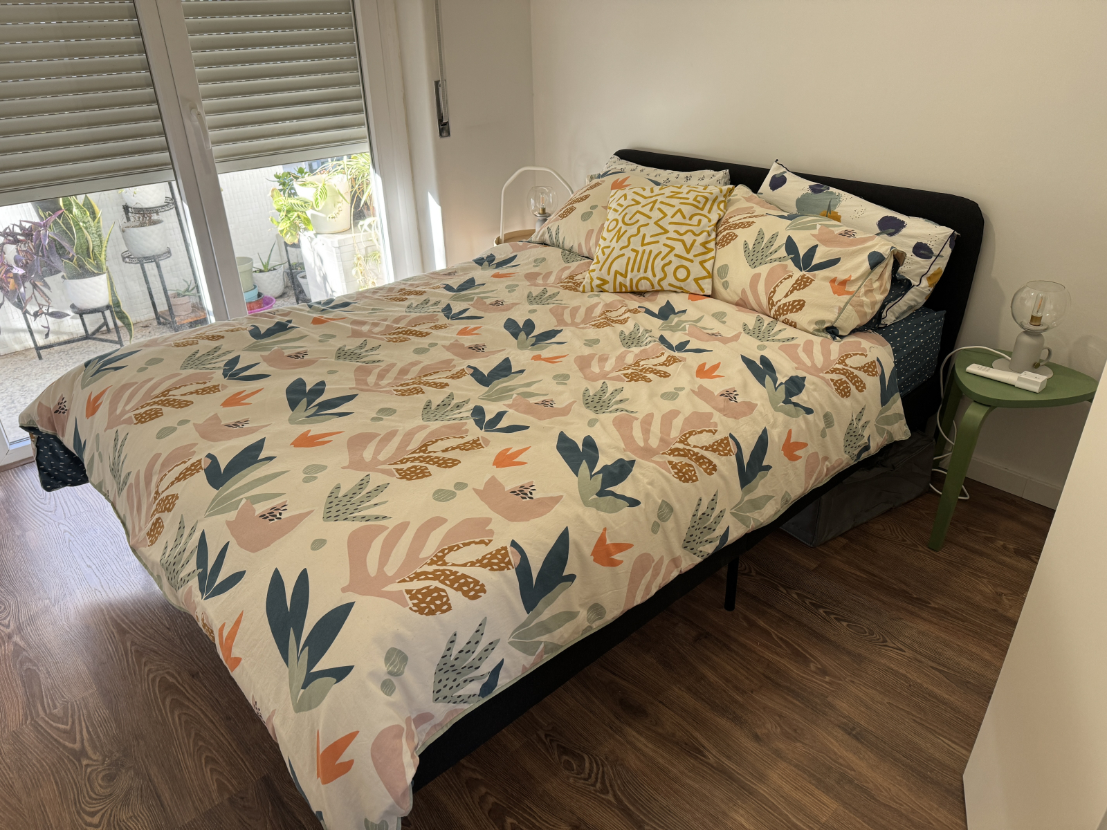 Guest room with double bed and includes split AC unit and door to balcony