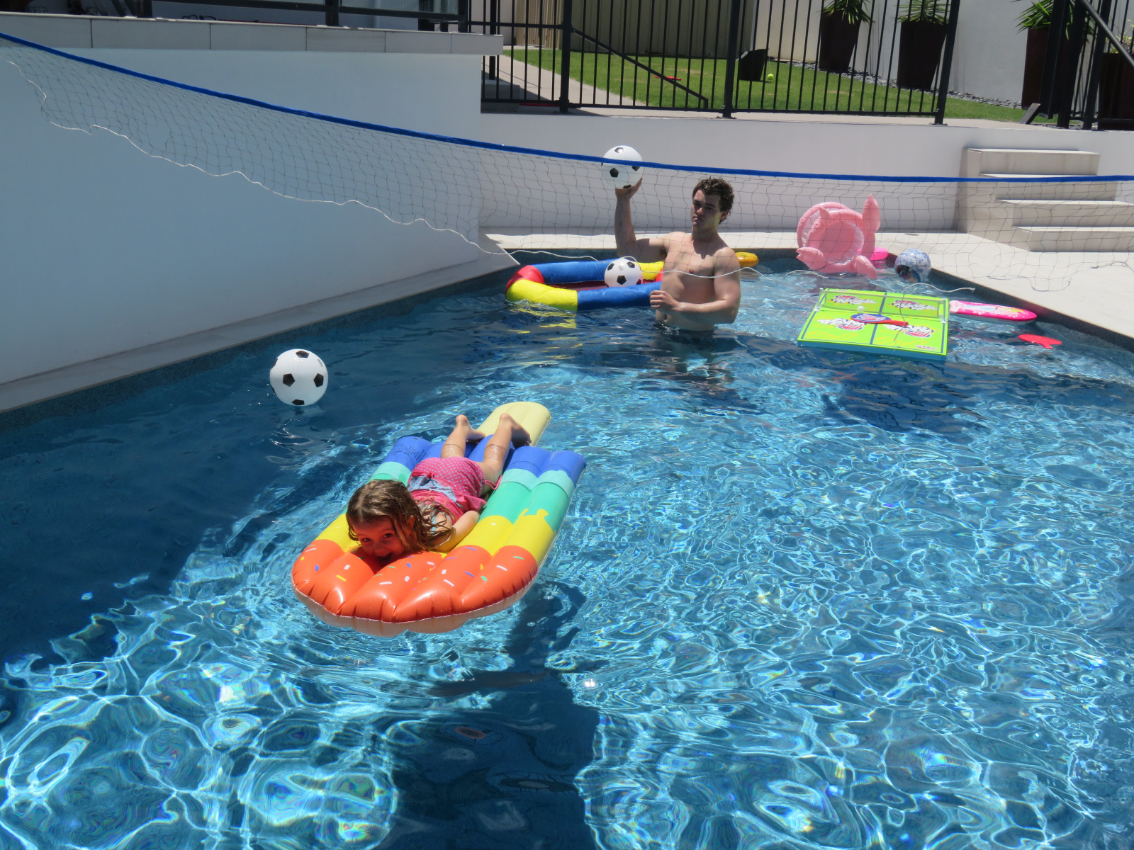 Volleyball in pool looking onto putting green.