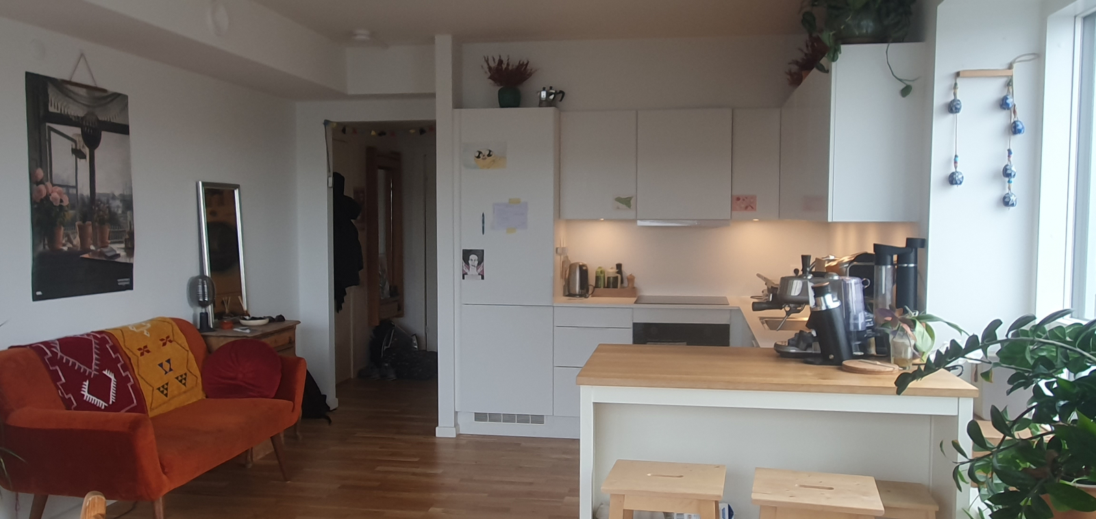fully equipped kitchen, including espresso machine and breakfast stools