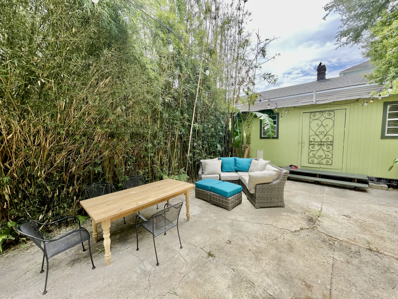 Back courtyard is full of bamboo, banana trees and palms with cafe lights for evening dining and cocktails. The back shed is where you'll find the washer and dryer. The shed is climate controlled and insulated but is mostly used for owners storage.