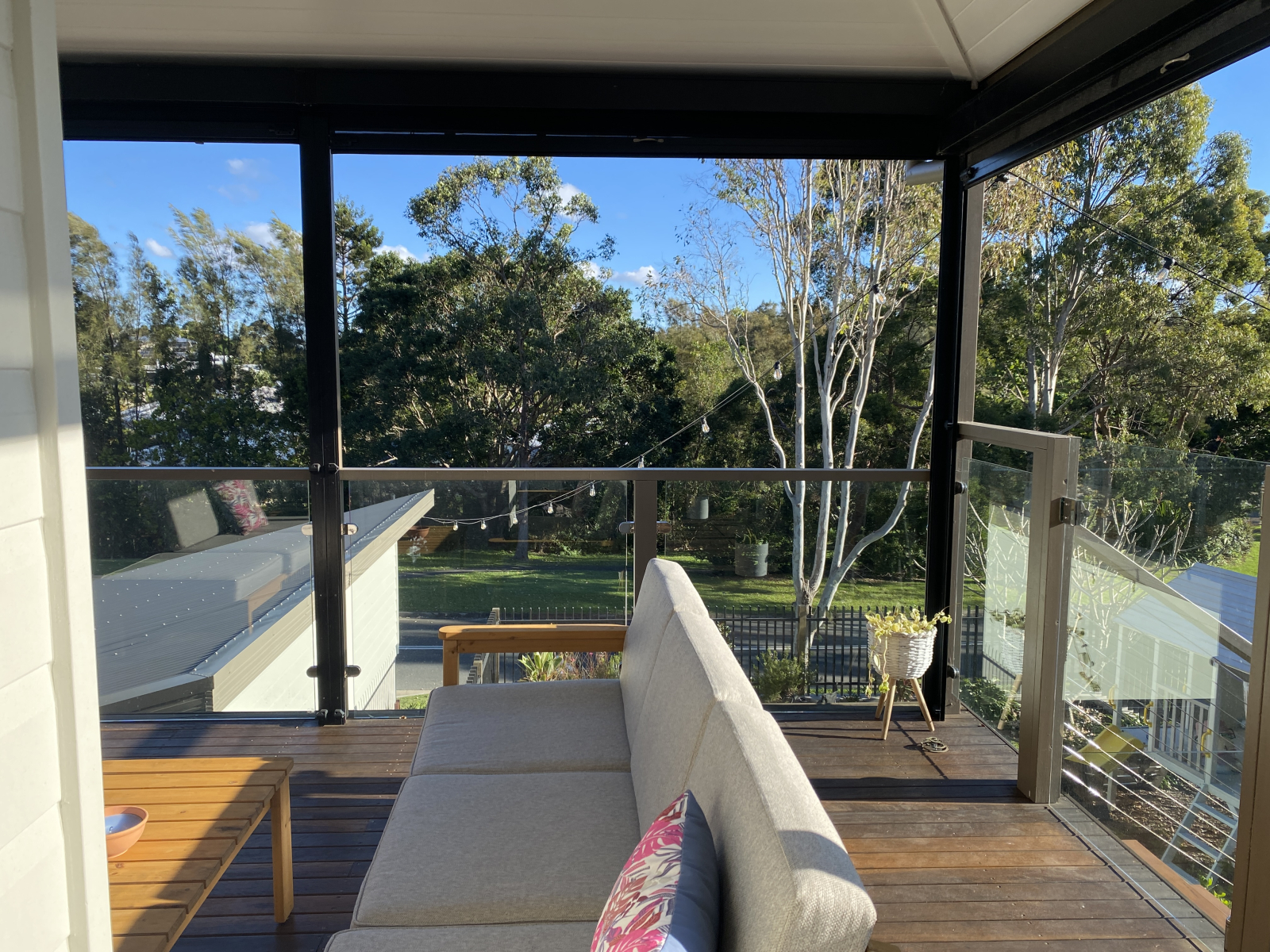 Covered deck on upper level with lovely views of the trees and reserve across the road. Enjoy coffee ...