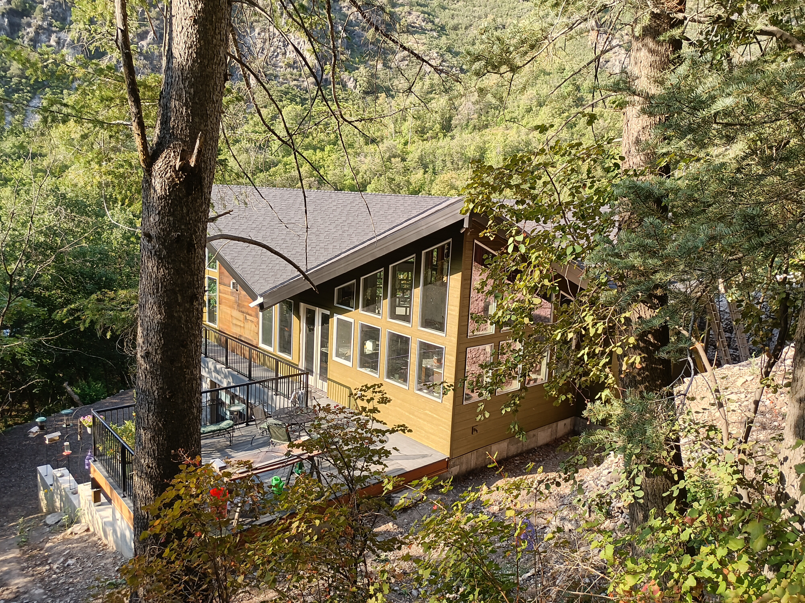 View  from our back yard forest of the kitchen corner, also showing rear deck.