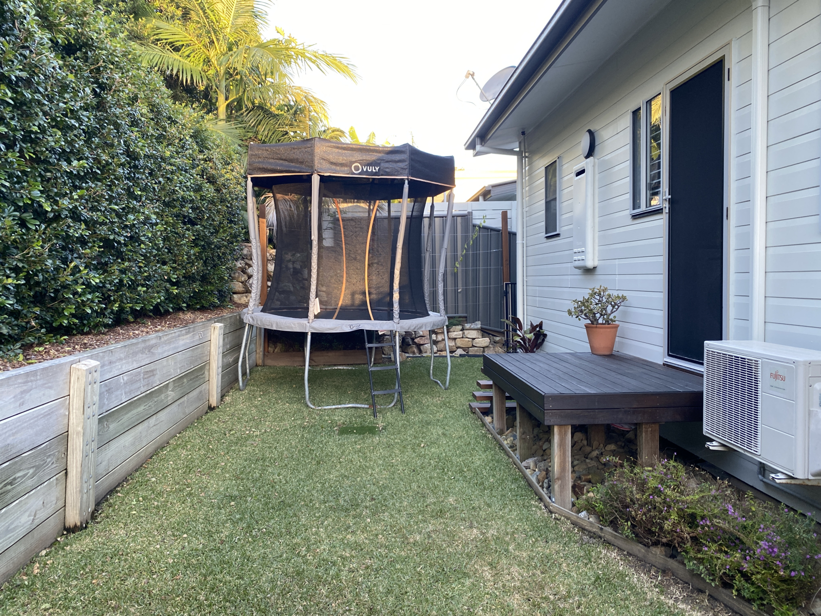 Backyard with a trampoline for the kids.