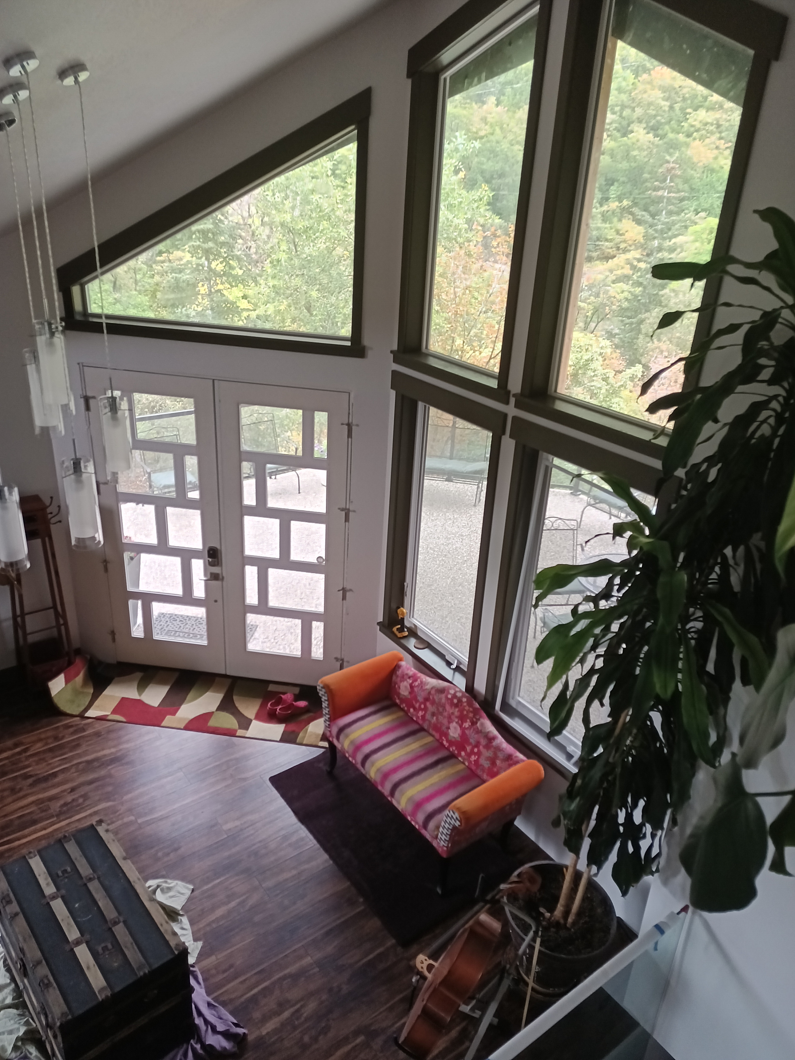 View from the mezzanine showing the entry door and the covered front deck outside.