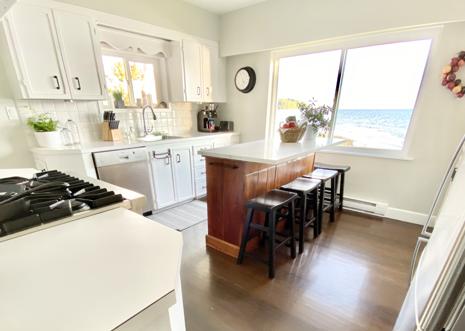 Kitchen (original) and updated with a dishwasher, gas stove and island for prep and gatherings.