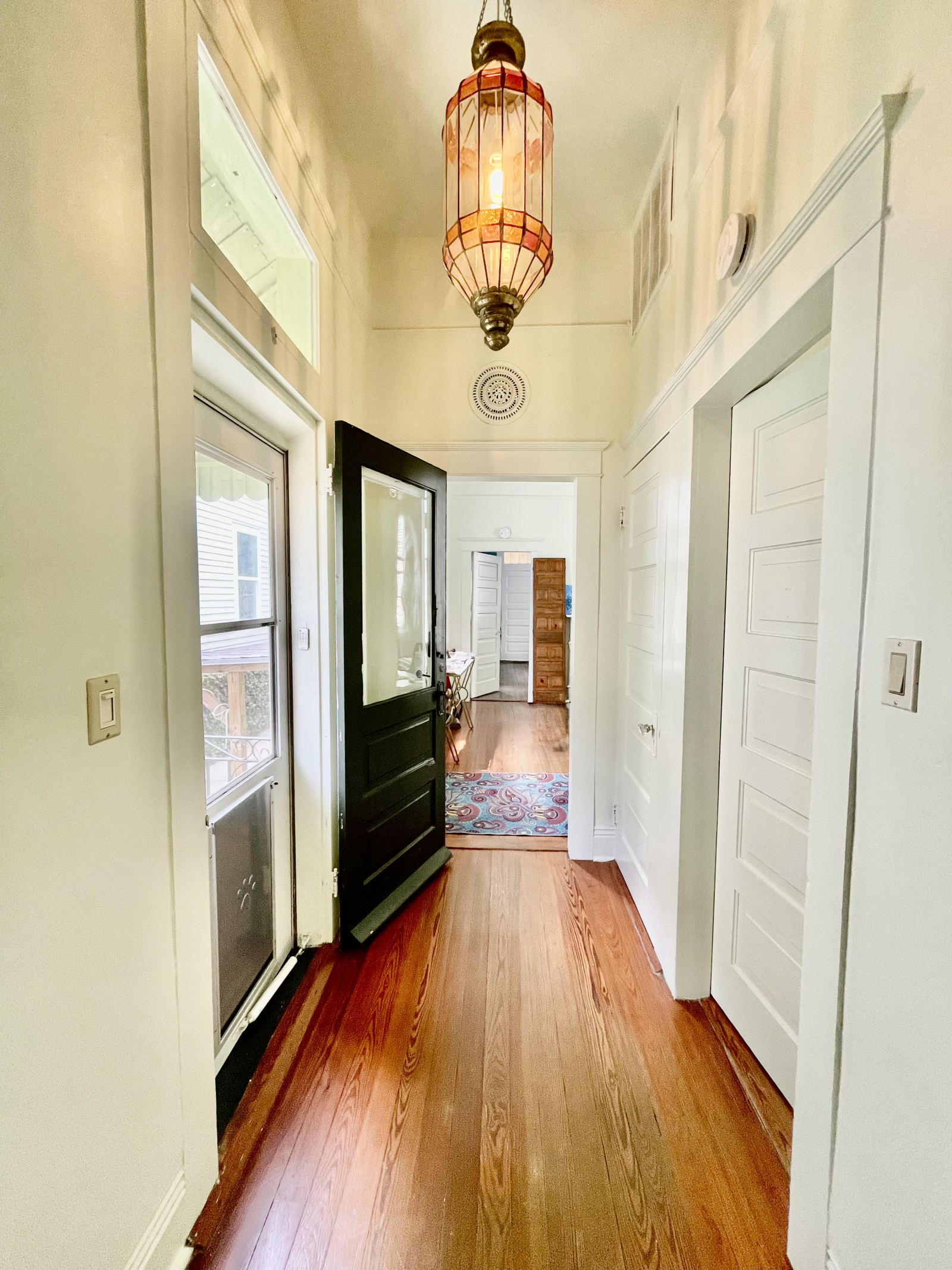 The New Orleans "shotgun" style home means one room leads to the next and you can open the back door and the front door and the breeze blows all the way through. This home also has a side door for even more sunlight and breeze.