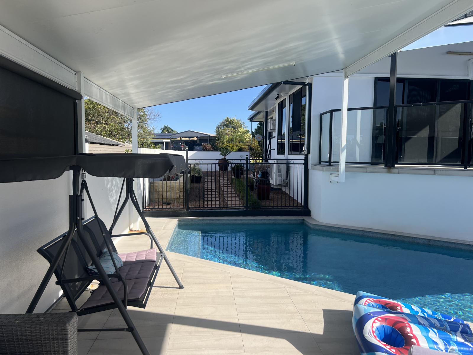 Pool and Swing chair leading to courtyard.